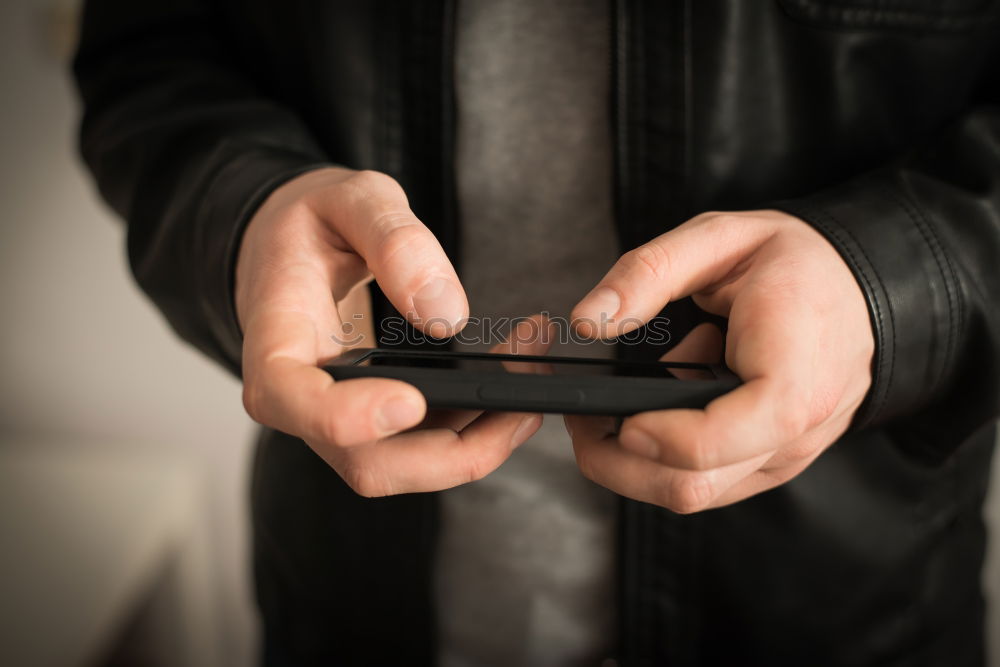 Similar – Tattooed man using a smartphone