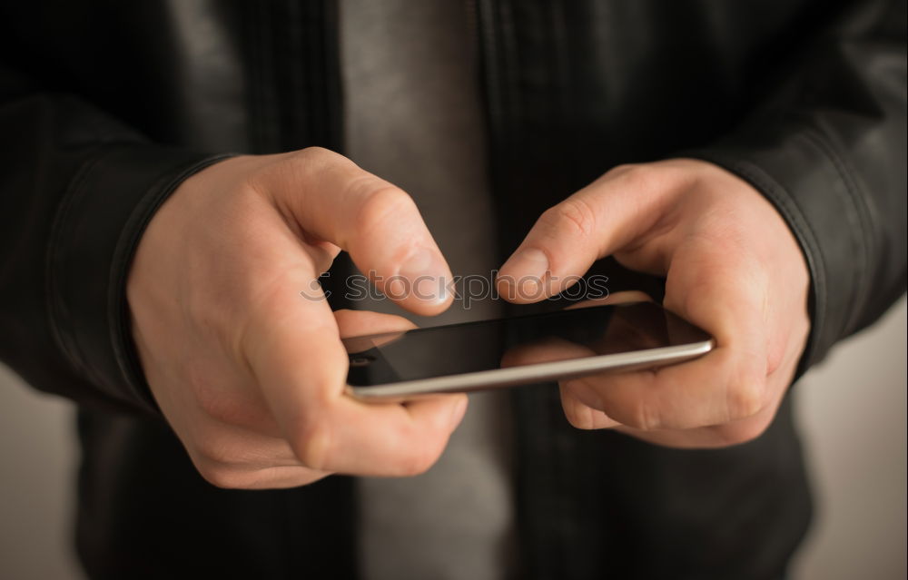 Tattooed man using a smartphone