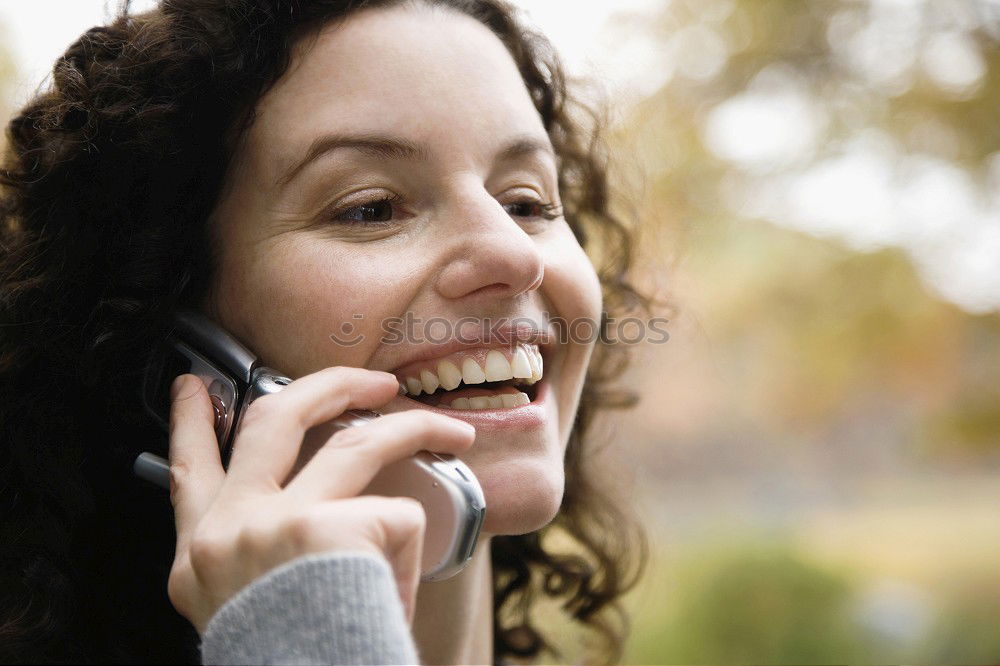 Similar – Smiling Woman in Autumn Fashion Talking on Phone