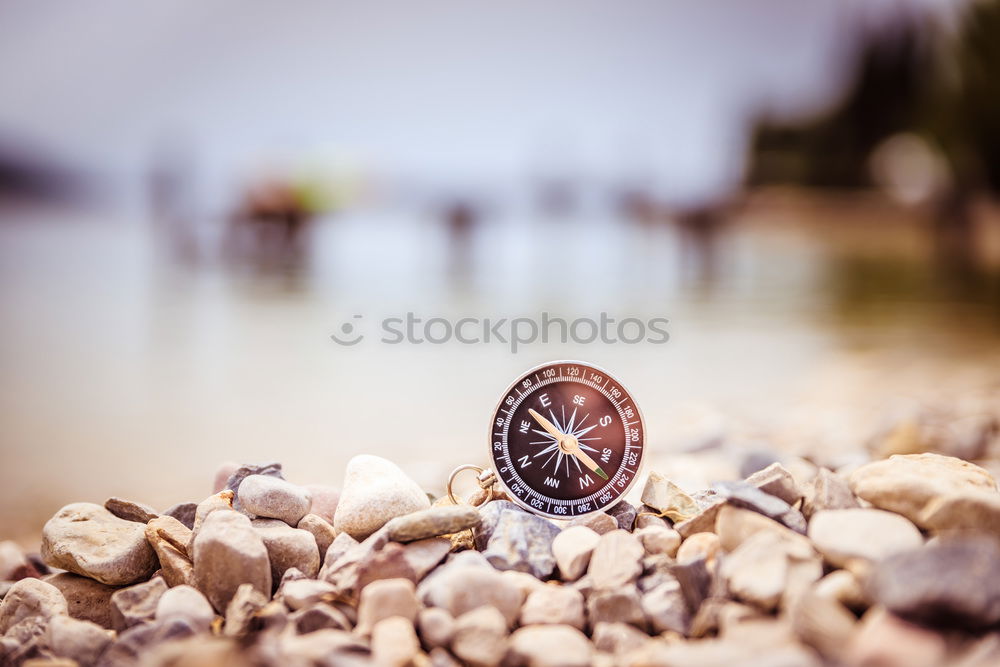 Similar – Glass orb on rocks by the sea covered