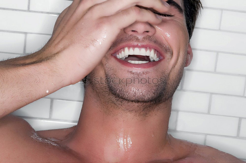 Similar – Young bearded man washing his hair