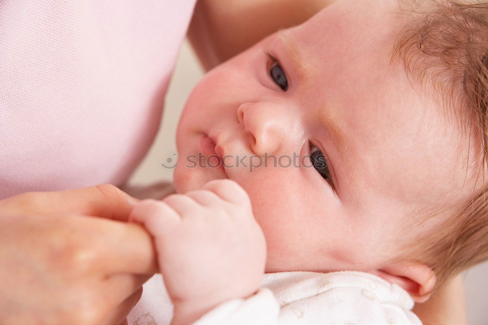 Similar – Image, Stock Photo Young mother breast feeding her baby at home
