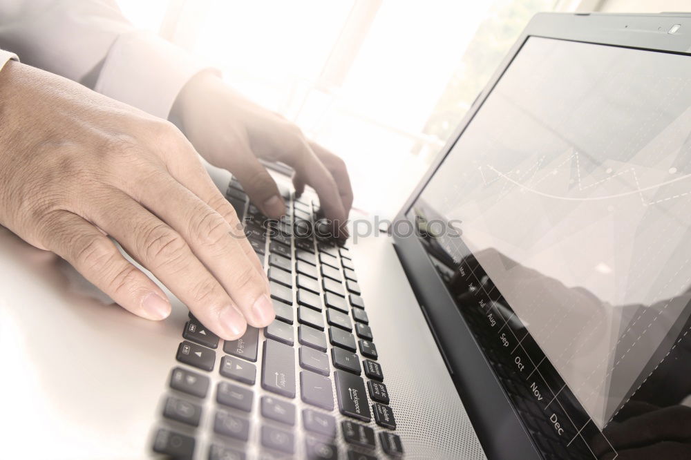 Similar – Young man works on a laptop in the start-up and listens to music through in-ear headphones