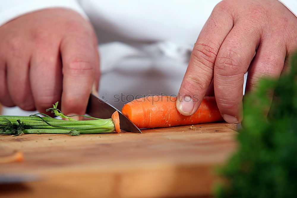 Similar – process of slicing carrots on slices on a kitchen board