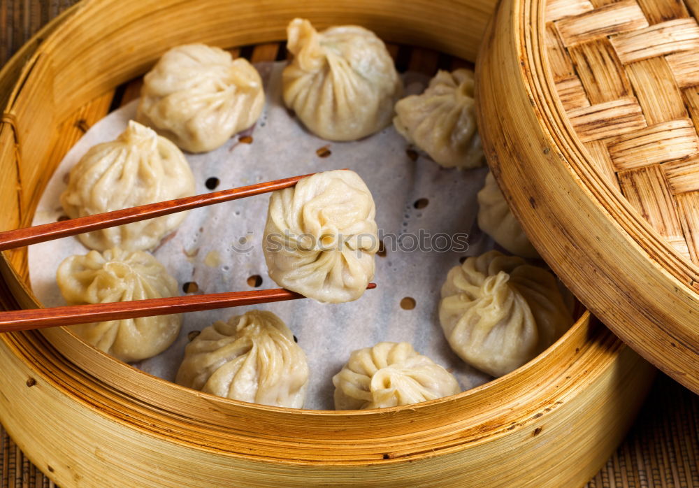 Dumplings or gyoza served in traditional steamer