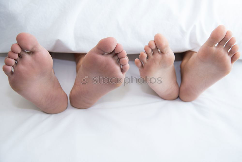 Similar – Happy children sitting on the bed barefoot.