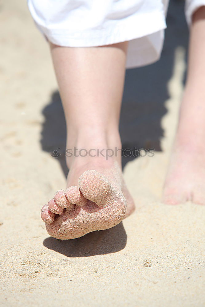 baby walking barefoot on stones