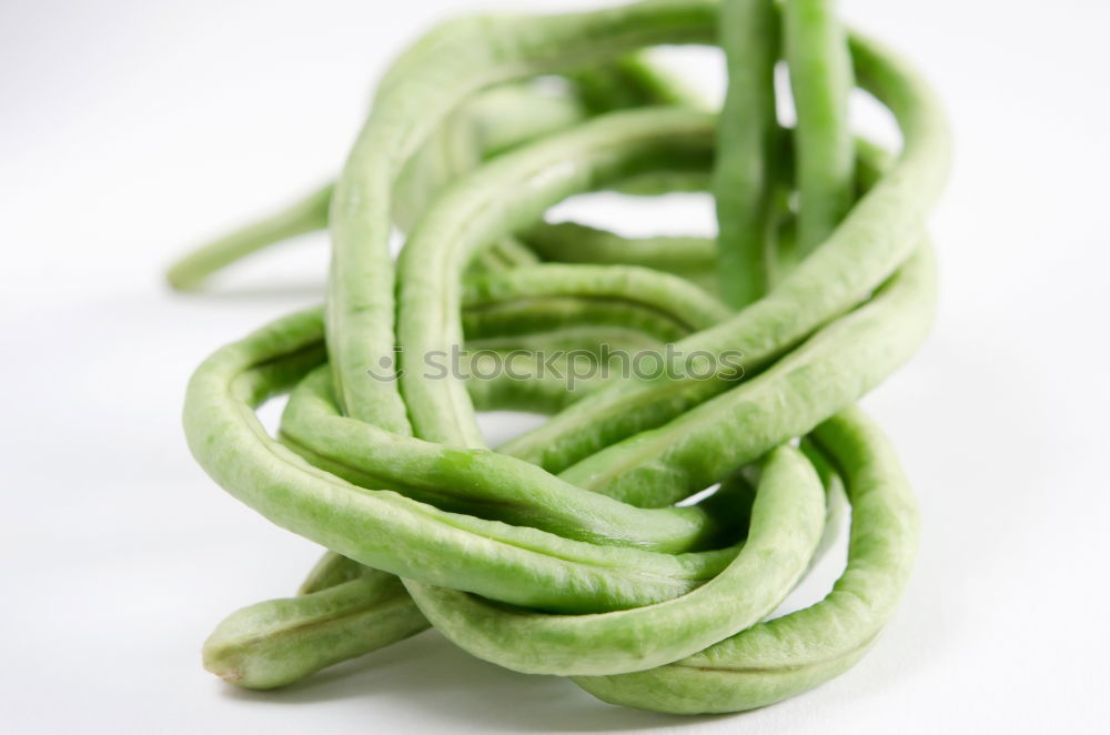 Similar – Image, Stock Photo A portion of green asparagus, freshly harvested from the local field, decorated with a plaid ribbon of cloth, tied together, lies in the light on the table, on a white cloth of linen.