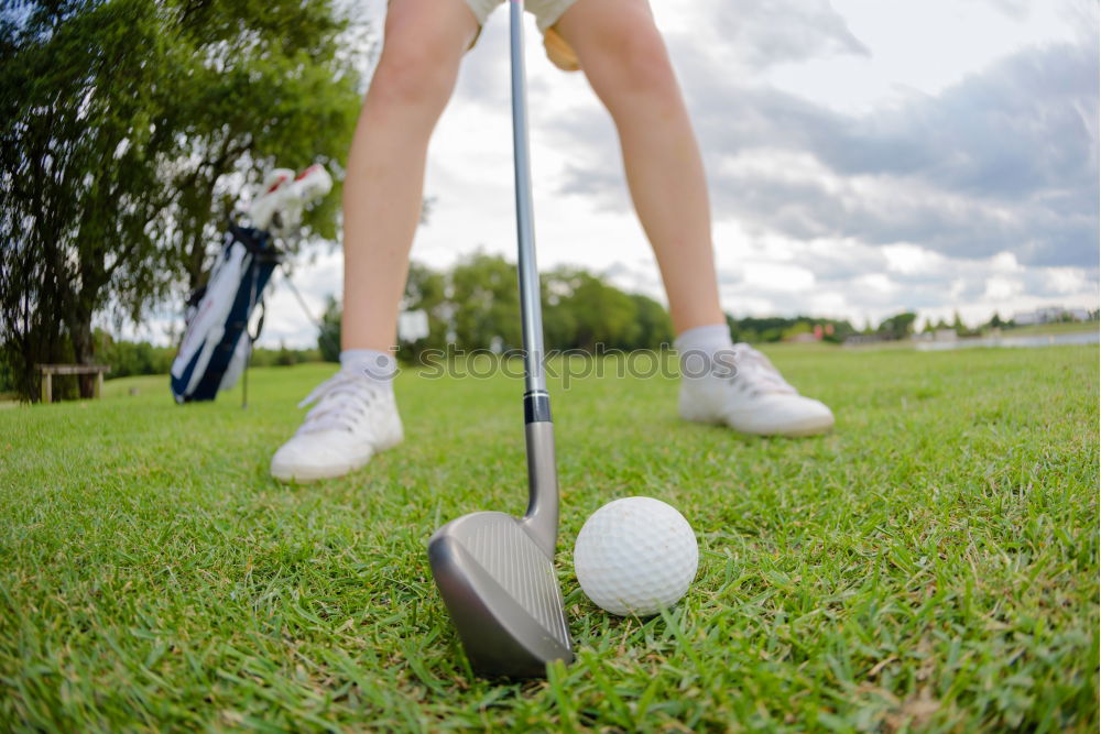 Similar – Golfer performs a golf shot from the fairway