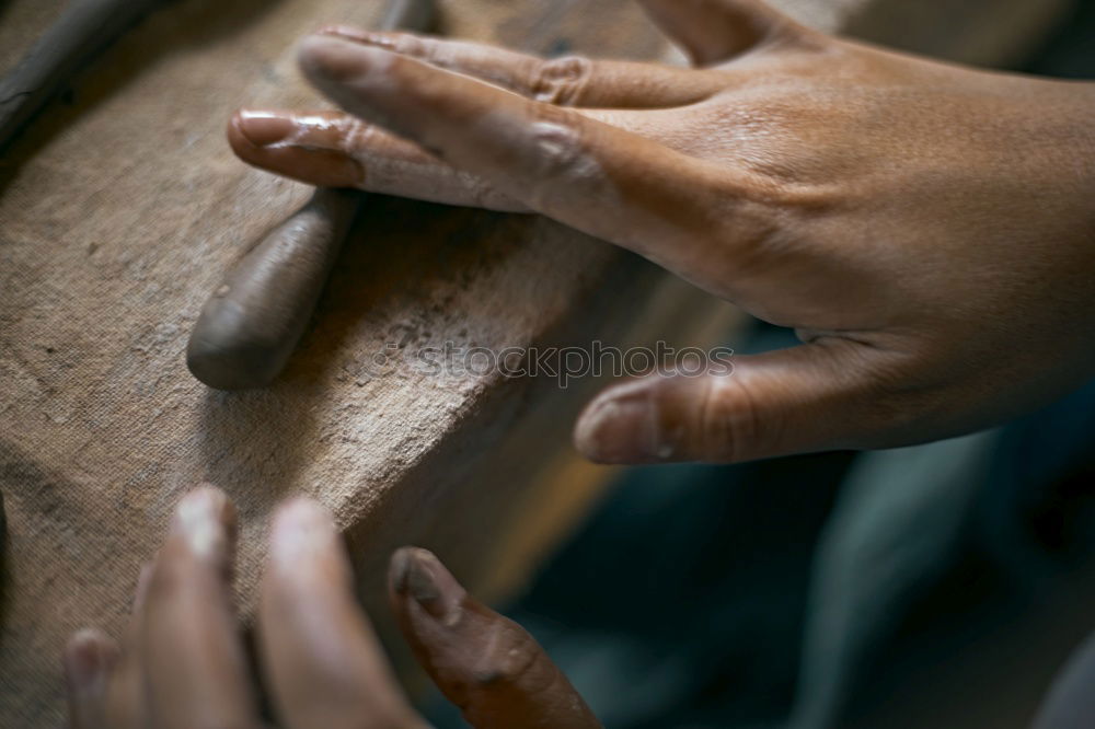 Similar – Hands of woodcarver make wooden bowl