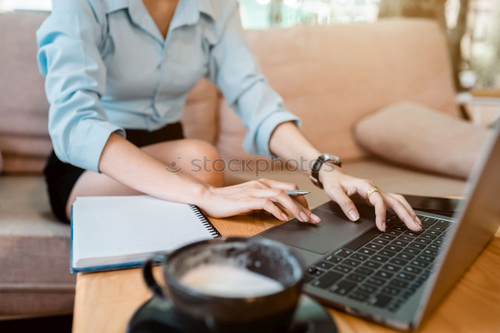 Similar – Young adult woman working on laptop in cafe