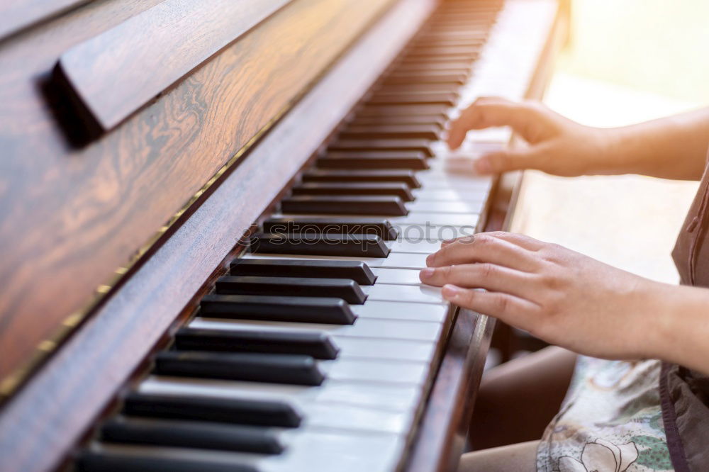 Similar – Toddler plays piano with delicate hands