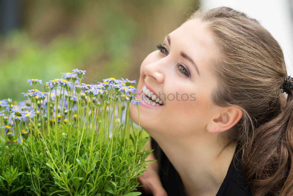 Similar – romantic portrait of happy child girl picking bouquet of beautiful blue delphinium flowers from summer garden