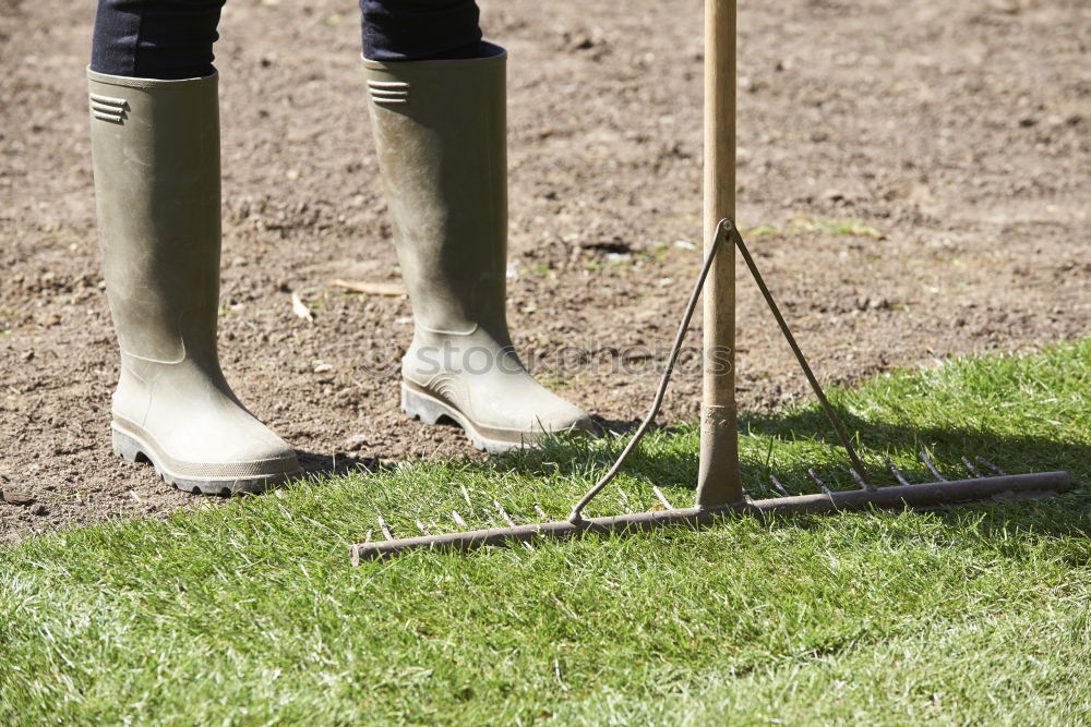 Similar – Legs in red trousers and green rubber boots jumping in a muddy puddle, so that the mud flies up