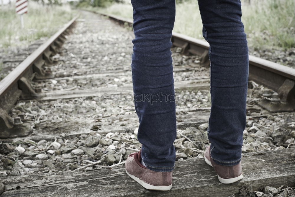 Similar – Blue jeans, boots with wooden smoking pipe