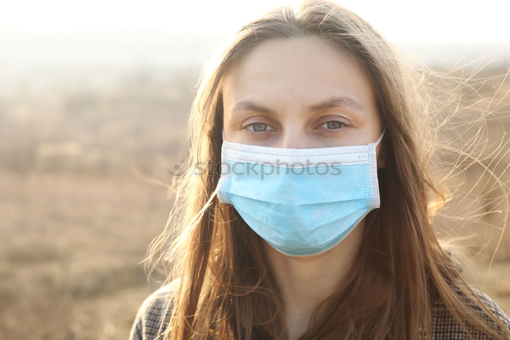 Similar – close up of Photo of a woman wearing protective mask against infectious diseases, coronavirus, covid-19 and flu outdoors. copy space. Coronavirus outbreak in Europe. Flu epidemic spread prevention