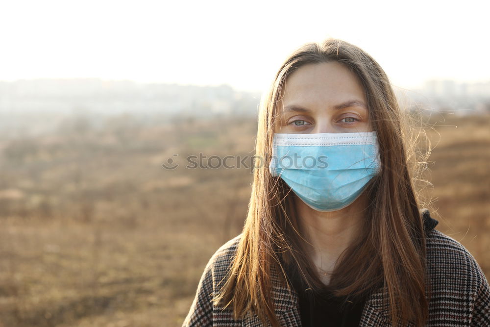 Similar – Young woman in medical mask standing near blooming flowers