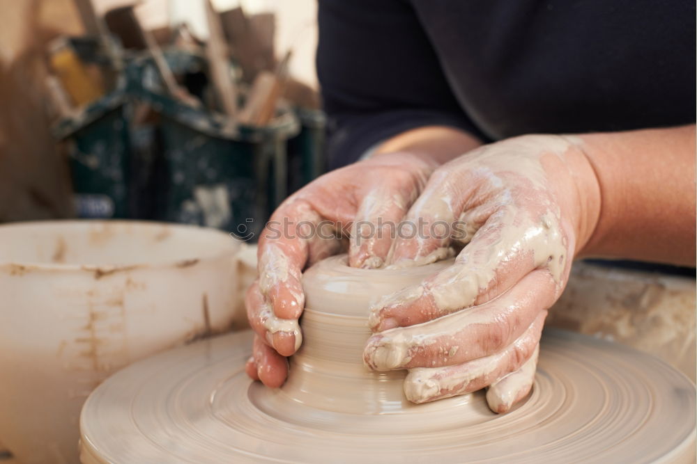 Similar – Image, Stock Photo Young female sitting by table and making clay or ceramic