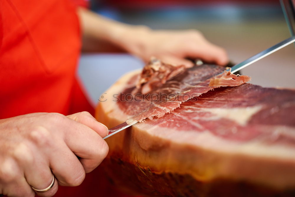 Similar – Image, Stock Photo Cutter carving slices from a whole bone-in serrano ham