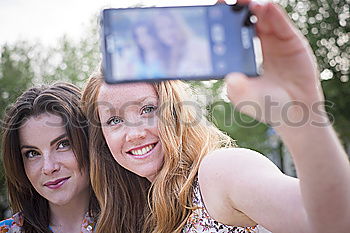 Similar – Image, Stock Photo Young adult hipster girlfriends taking selfie and pulling faces