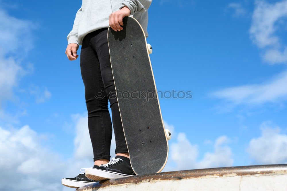 Hands holding skateboard