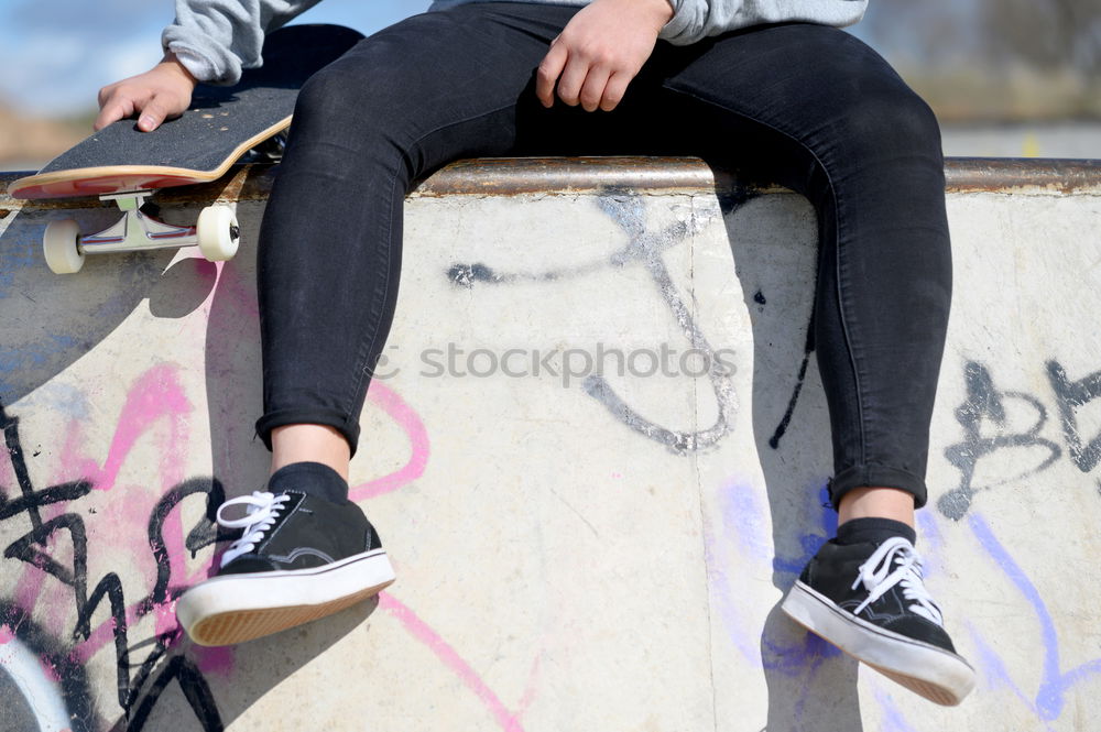 Image, Stock Photo A beautiful teenager is sitting on a skateboard in a special area of the Park. A boy is resting after riding in a skatepark. Active rest in the fresh air