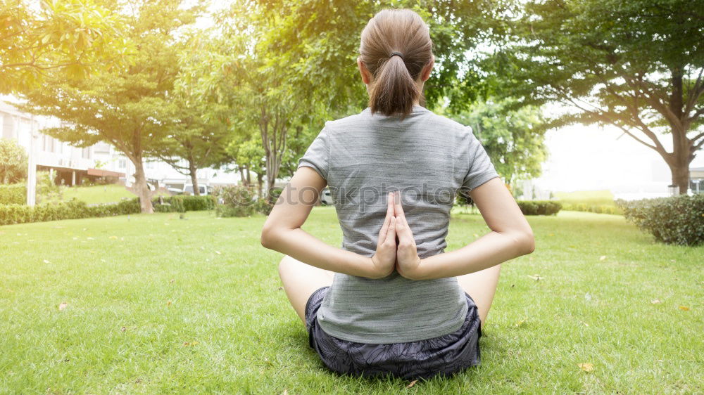 Image, Stock Photo Mother and daughter doing yoga exercises on grass in the park at the day time