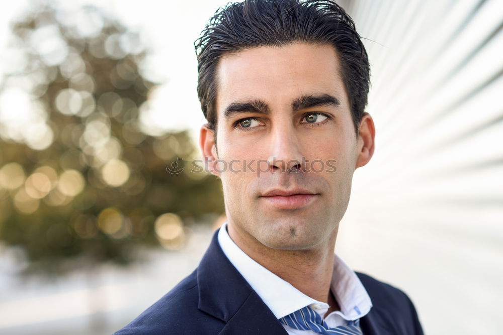 Businessman wearing blue suit and tie outdoors