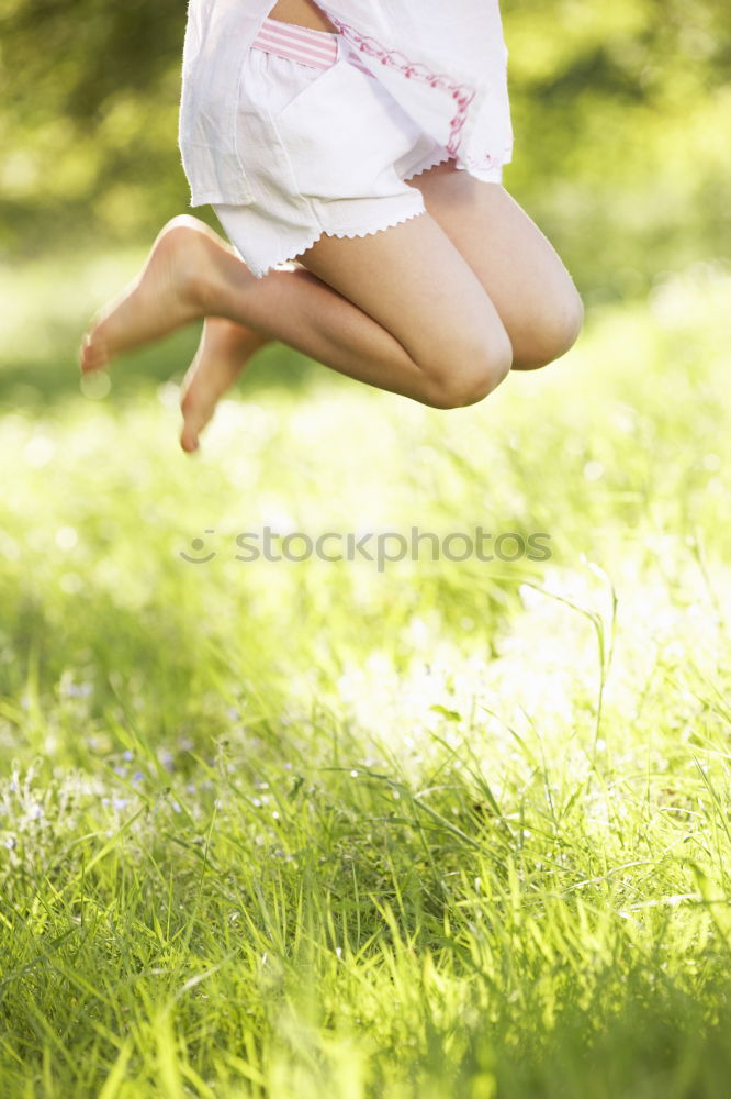 Similar – Happy little girl is smiling and  swinging  in the garden in a sunny summer day.