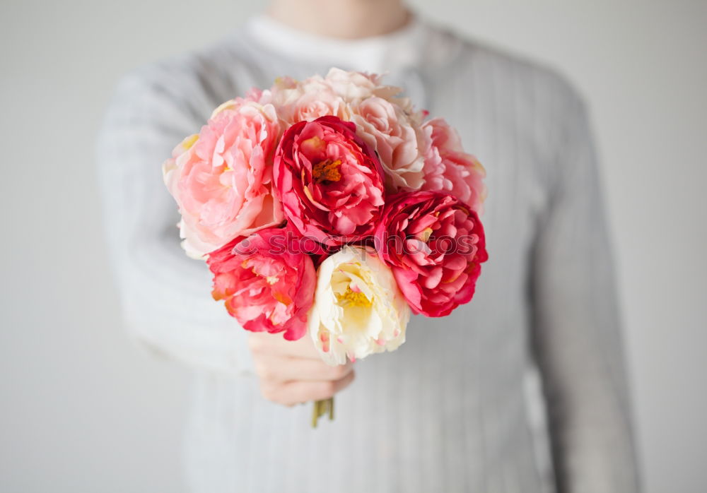 Similar – Young woman holding flowers in hand