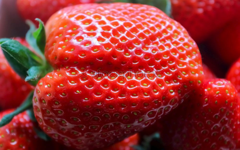 Similar – red strawberries with green stems in sale trays