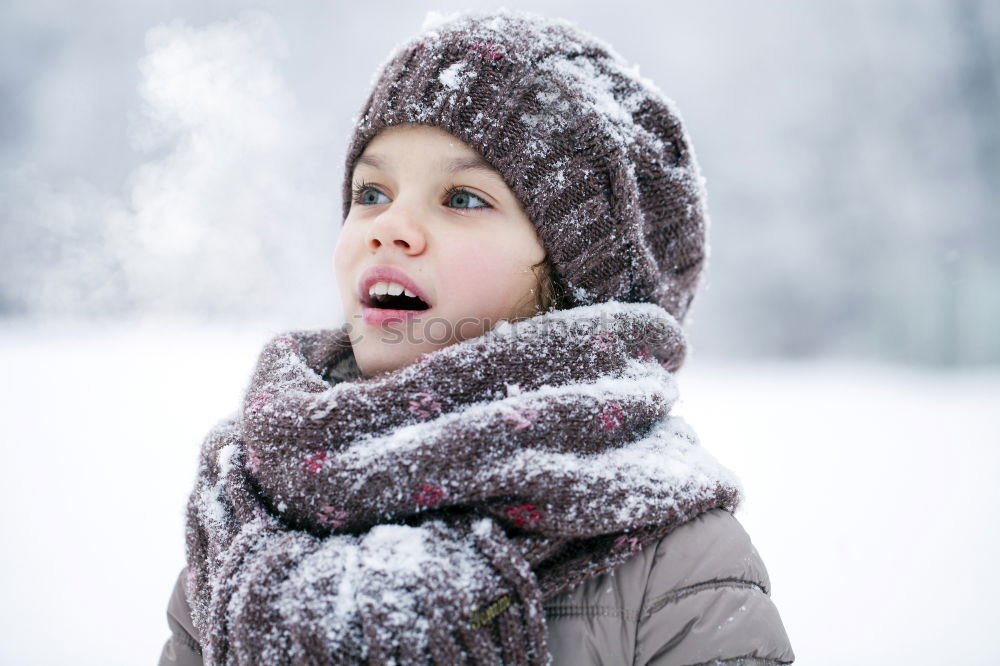 Similar – baby girl in knitted scarf walking in winter forest