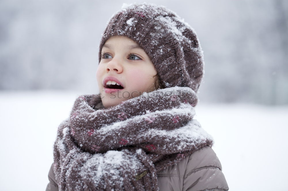 Similar – baby girl in knitted scarf walking in winter forest