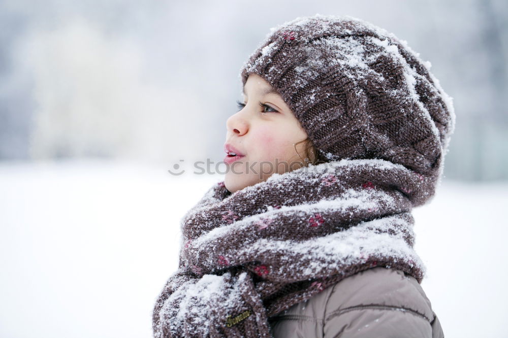 Similar – Little boy having fun playing with fresh snow during snowfall. Baby catching snowflakes on gloves. Kid dressed in warm clothes, hat, hand gloves and scarf. Active winter outdoors leisure for child