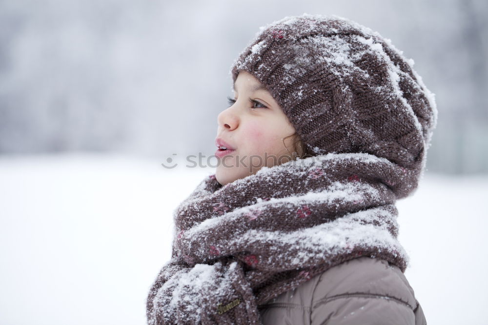 Similar – Little boy having fun playing with fresh snow during snowfall. Baby catching snowflakes on gloves. Kid dressed in warm clothes, hat, hand gloves and scarf. Active winter outdoors leisure for child