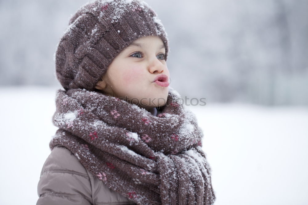 Similar – baby girl in knitted hat walking in winter forest