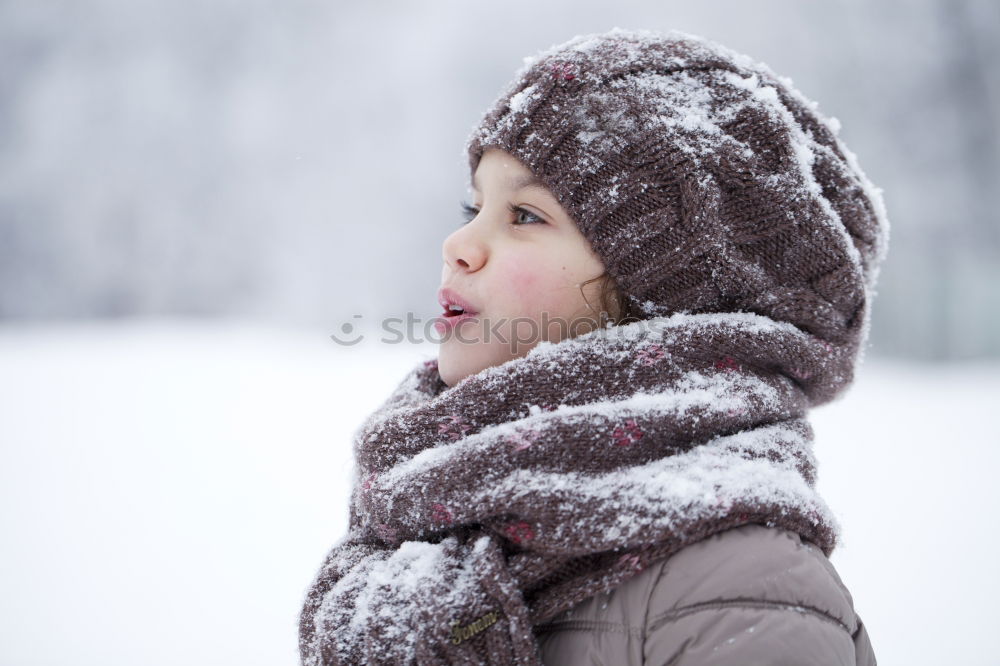 Similar – Little boy having fun playing with fresh snow during snowfall. Baby catching snowflakes on gloves. Kid dressed in warm clothes, hat, hand gloves and scarf. Active winter outdoors leisure for child