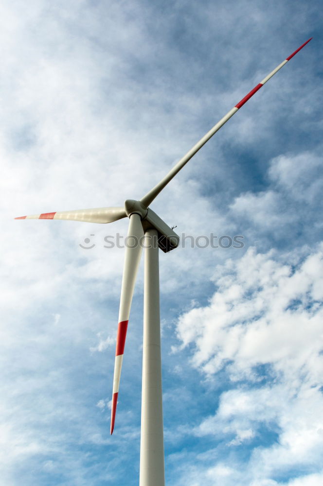 Similar – Image, Stock Photo Wind turbine for renewable power generation in front of a dike on the North Sea coast, long straight road. Wind turbine