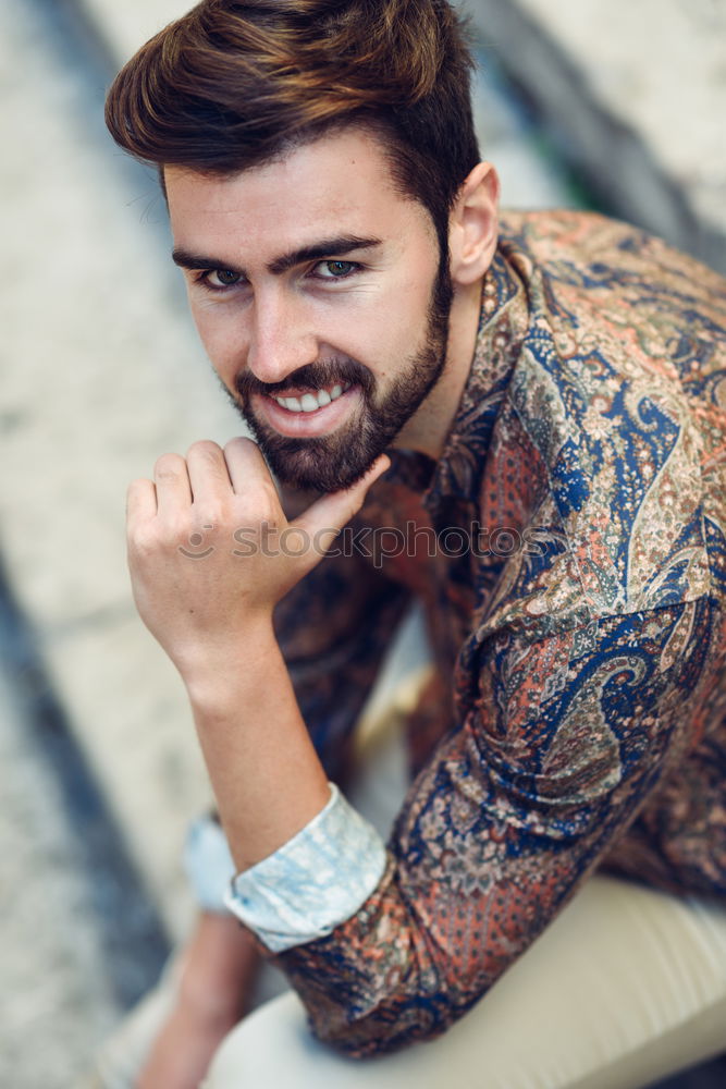 Similar – Young bearded man, model of fashion, sitting on urban step