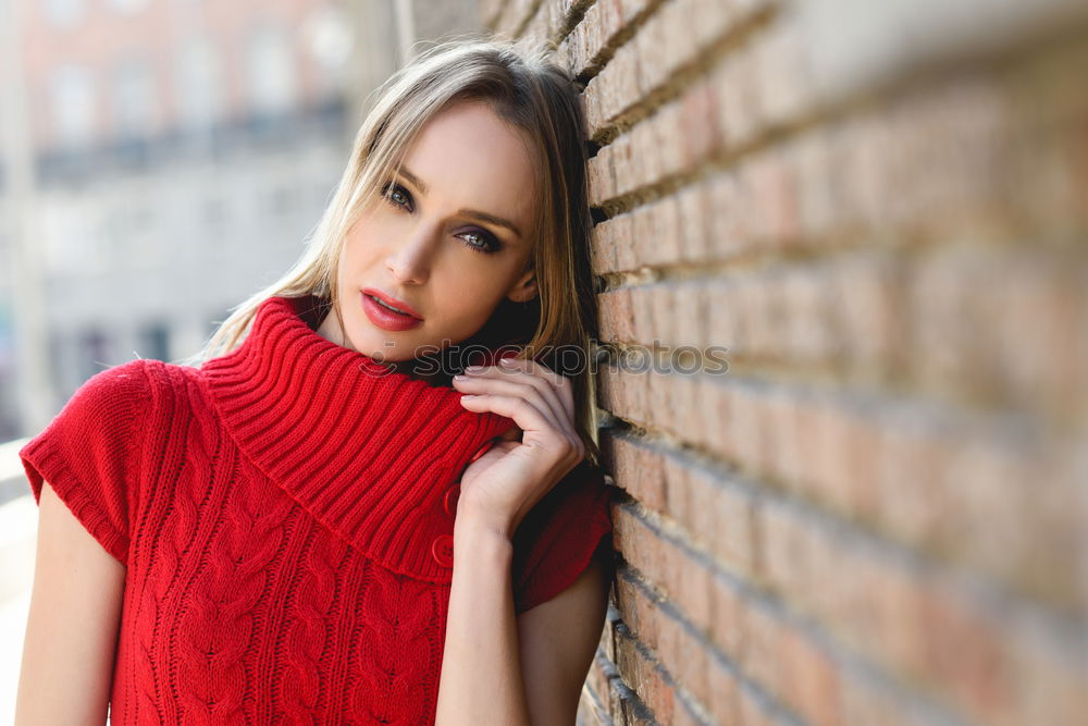 Similar – Portrait of a young blonde woman gesturing in the street wearing a red sweeter