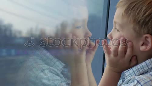 Similar – Image, Stock Photo Little boy sitting in his seat during a flight and painting on a tablet computer in an airplane