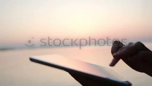 Similar – Image, Stock Photo Happy young woman with tablet PC on beach at sunset. Evening sun, sea and beach on background