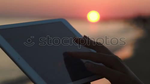 Similar – Image, Stock Photo Close-up shot ofwoman working with tablet computer on sunset and sea background