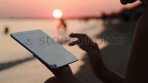 Similar – Image, Stock Photo Happy young woman with tablet PC on beach at sunset. Evening sun, sea and beach on background