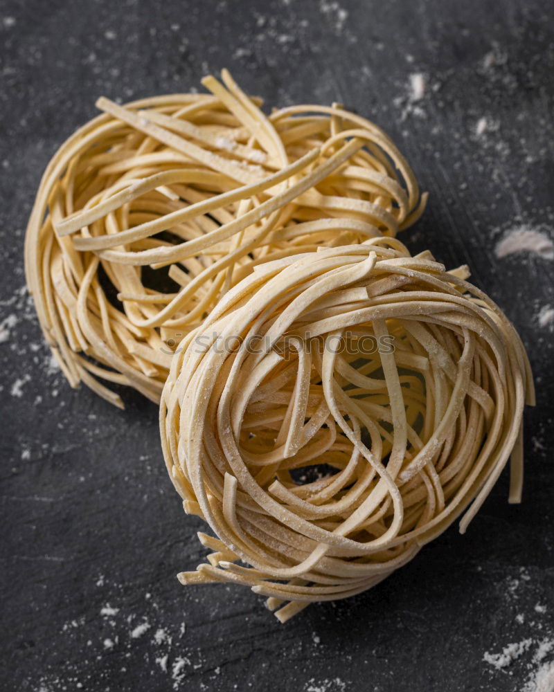 Similar – Raw tagliatelle on dark table