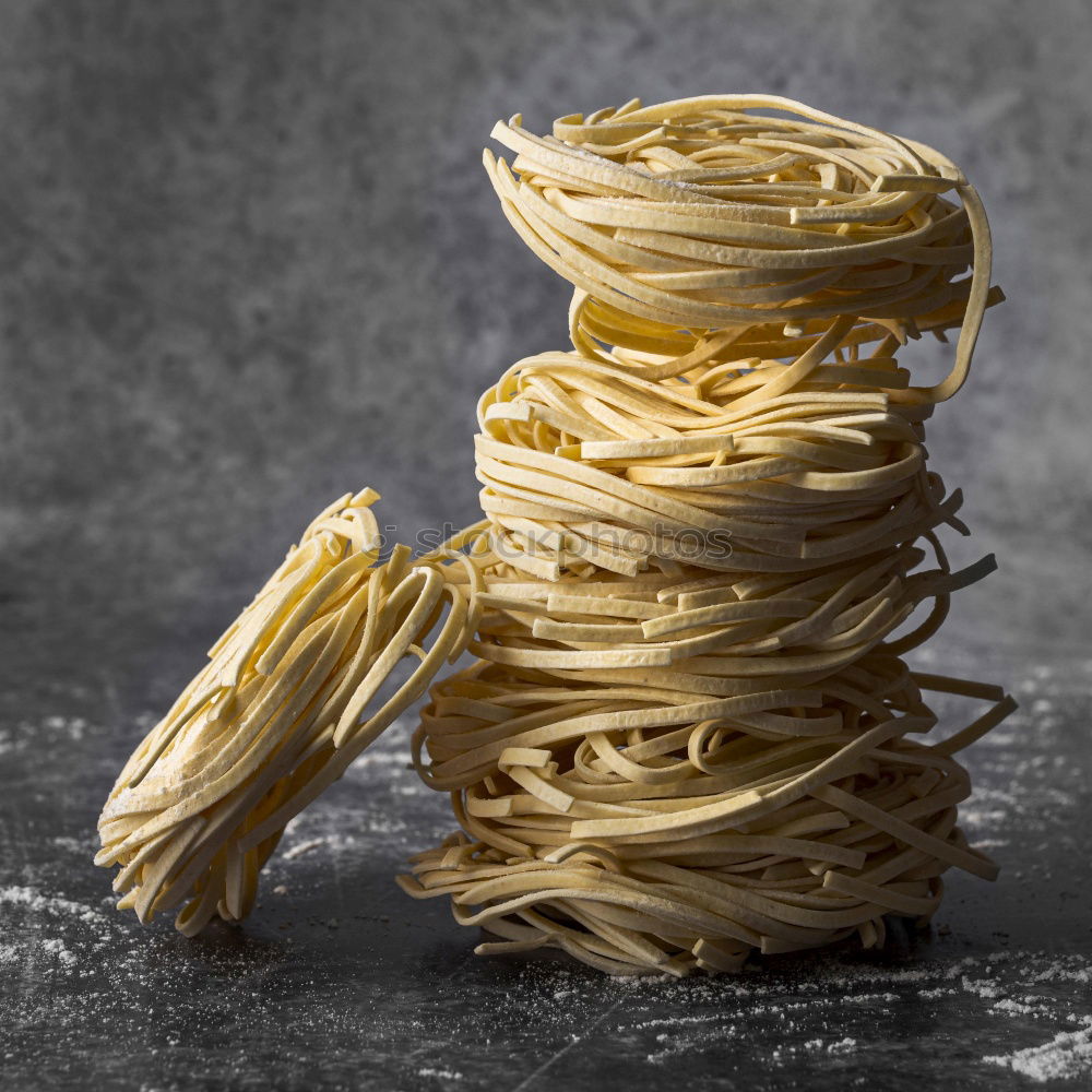 Similar – Raw tagliatelle on dark table