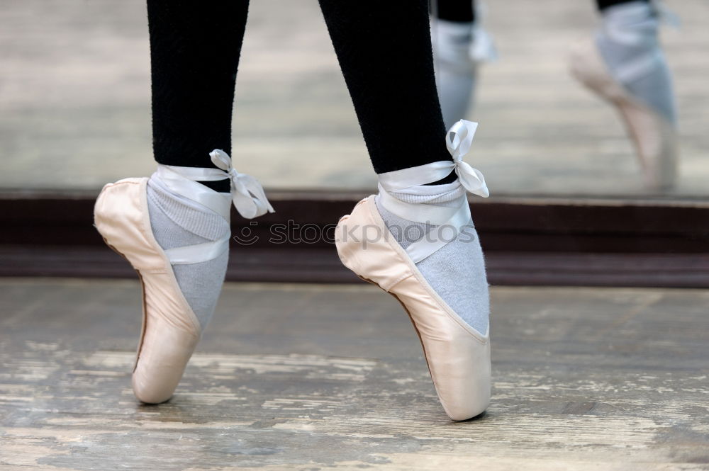 Image, Stock Photo Close up view to ballerinas legs in white pointes on wooden floor in point position.