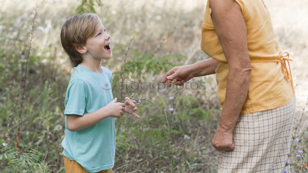 Similar – Image, Stock Photo Smiling little child with smart phone taking picture of happy grandmother and grandfather. Family leisure outdoor