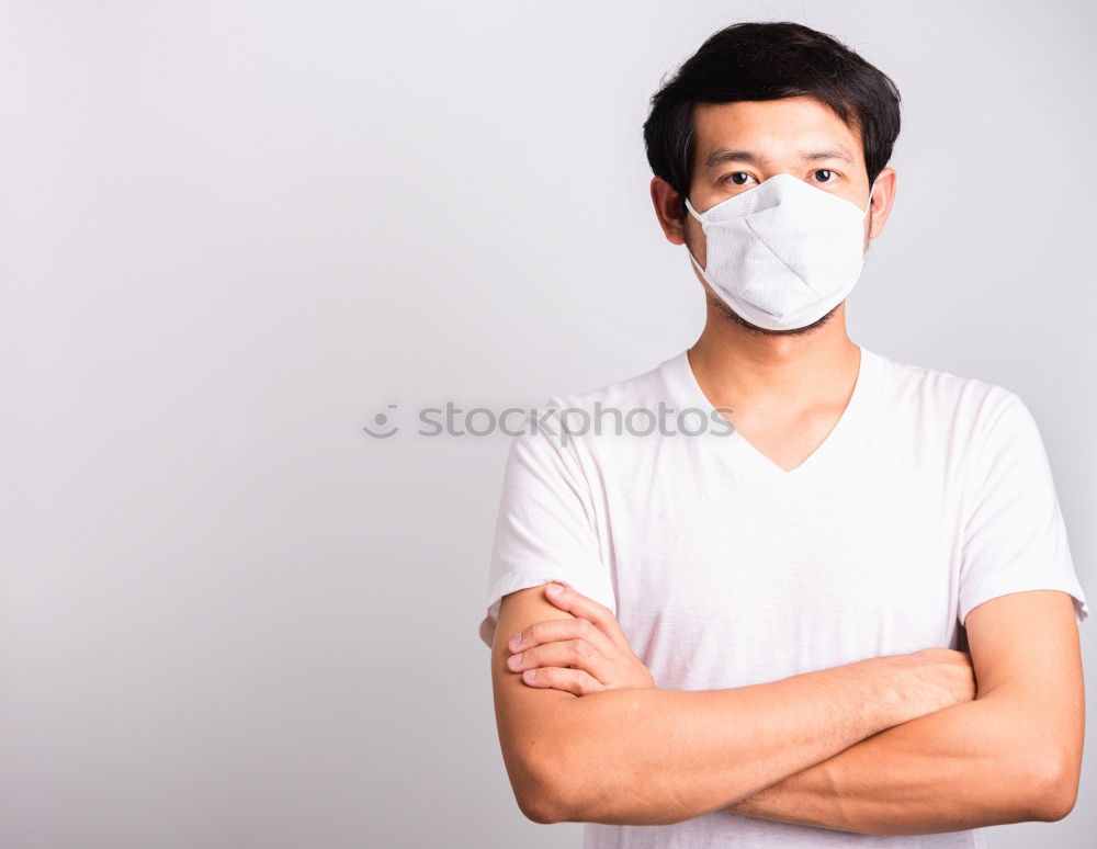 Similar – Man with facial mask and sunglasses looking at camera