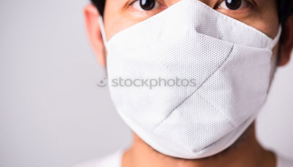 Similar – Man with facial mask and sunglasses looking at camera